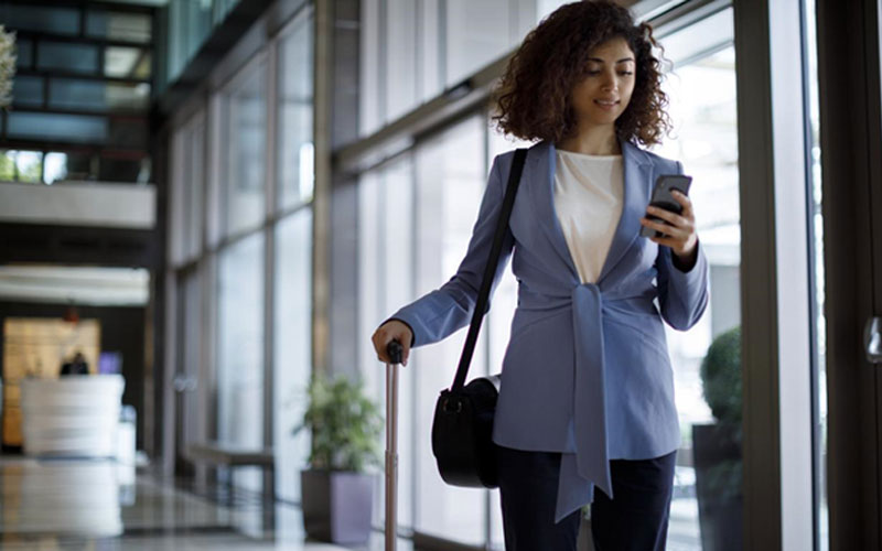 woman traveler direct booking a hotel on her phone